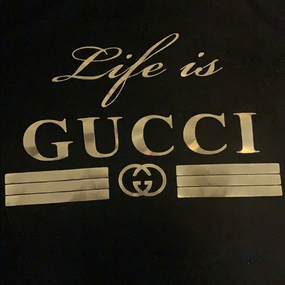 Medium sleeve black and gold “life is Gucci” shirt